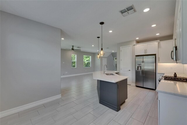 4899 Isola Ct, Wesley Chapel, FL 33543 - kitchen featuring appliances with stainless steel finishes, a sink, recessed lighting, baseboards, and ceiling fan
