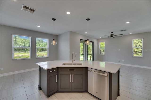 4899 Isola Ct, Wesley Chapel, FL 33543 - kitchen featuring stainless steel dishwasher, a sink, light countertops, recessed lighting, and baseboards