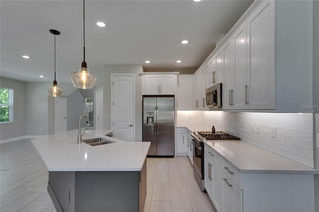 4899 Isola Ct, Wesley Chapel, FL 33543 - kitchen featuring stainless steel appliances, a sink, backsplash, recessed lighting, and a kitchen island with sink