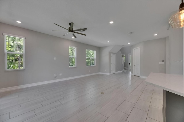 4899 Isola Ct, Wesley Chapel, FL 33543 - unfurnished living room featuring ceiling fan, plenty of natural light, baseboards, and recessed lighting