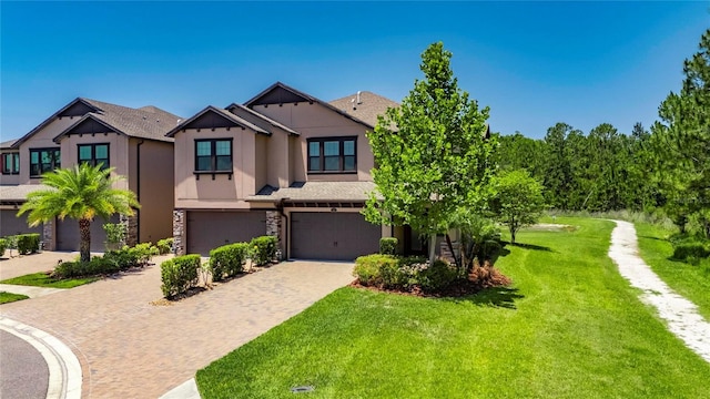 4899 Isola Ct, Wesley Chapel, FL 33543 - view of front facade featuring an attached garage, driveway, a front yard, stucco siding, and stone siding