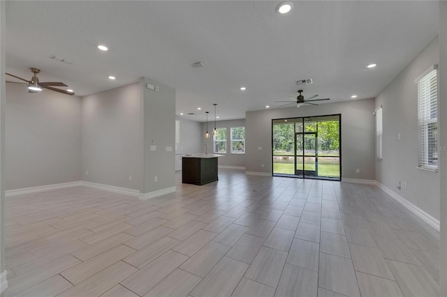 4899 Isola Ct, Wesley Chapel, FL 33543 - empty room featuring a ceiling fan, recessed lighting, baseboards, and a sink