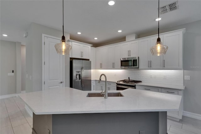 4899 Isola Ct, Wesley Chapel, FL 33543 - kitchen featuring appliances with stainless steel finishes, a sink, decorative backsplash, baseboards, and white cabinetry