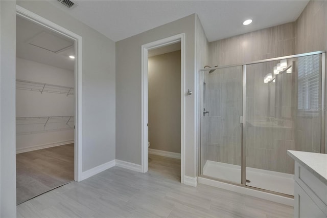4899 Isola Ct, Wesley Chapel, FL 33543 - bathroom with a shower stall, toilet, a walk in closet, baseboards, and vanity