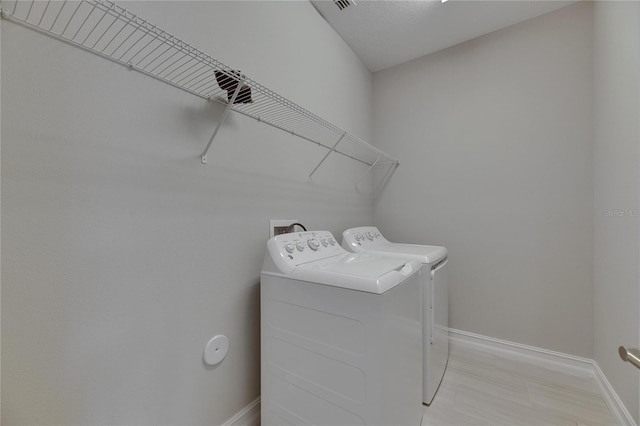 4899 Isola Ct, Wesley Chapel, FL 33543 - washroom with washer and dryer and baseboards