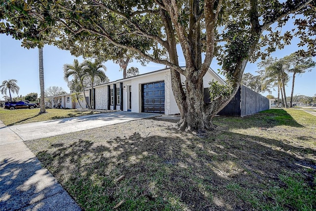 view of front of house featuring a garage and a front lawn