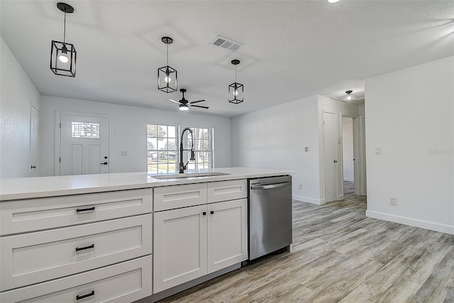 kitchen with white cabinetry, sink, hanging light fixtures, stainless steel dishwasher, and light hardwood / wood-style floors