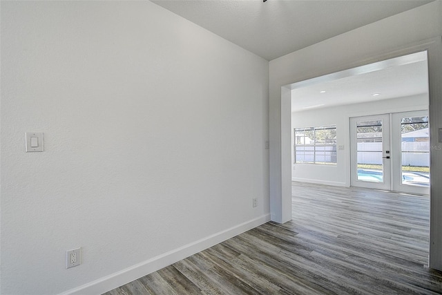 empty room featuring hardwood / wood-style flooring and french doors