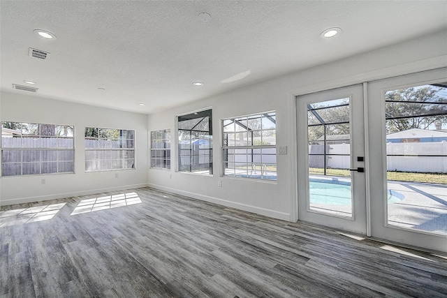 unfurnished sunroom with french doors