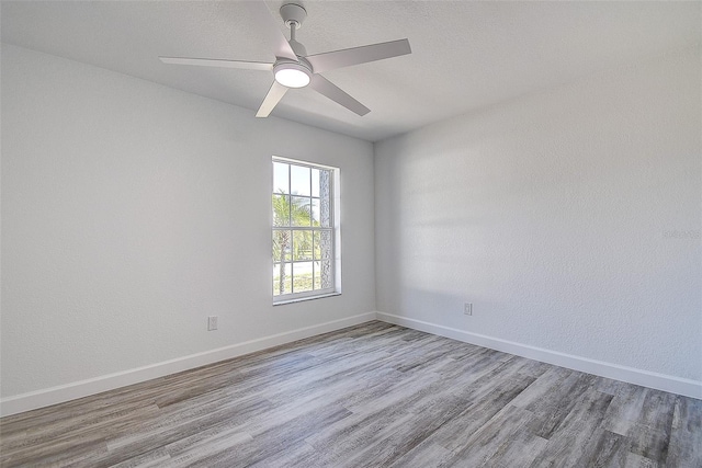 spare room featuring ceiling fan and light wood-type flooring