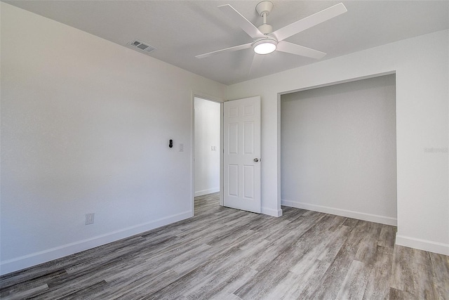 unfurnished bedroom featuring a closet, ceiling fan, and light wood-type flooring