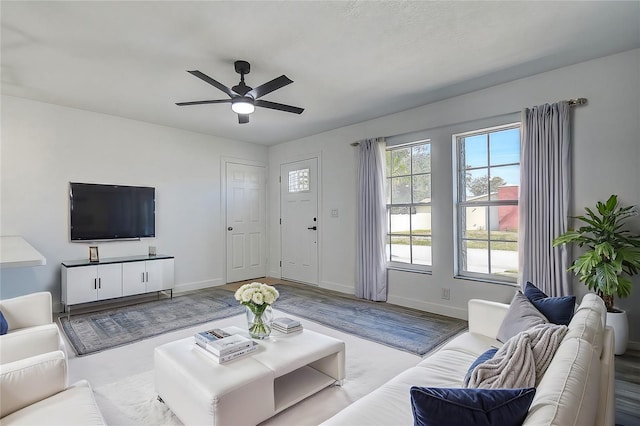 living room featuring light hardwood / wood-style flooring and ceiling fan