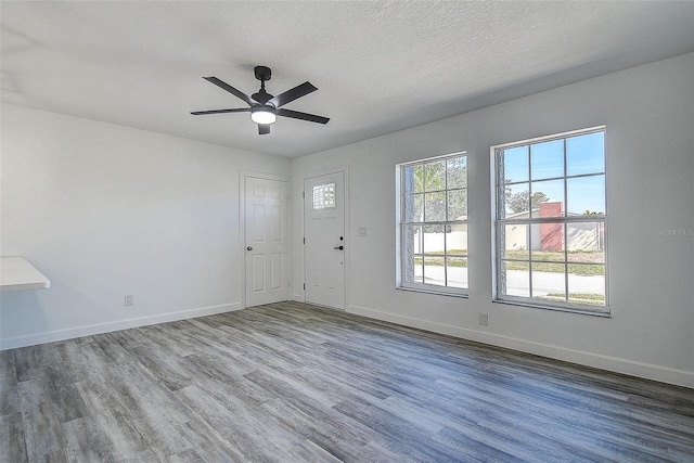 foyer with hardwood / wood-style flooring, ceiling fan, and a textured ceiling