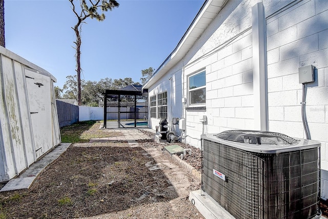 view of yard featuring a pool, a lanai, and central air condition unit