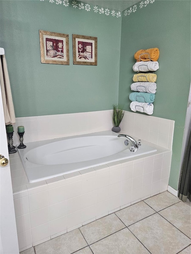 bathroom with tile patterned floors and tiled bath