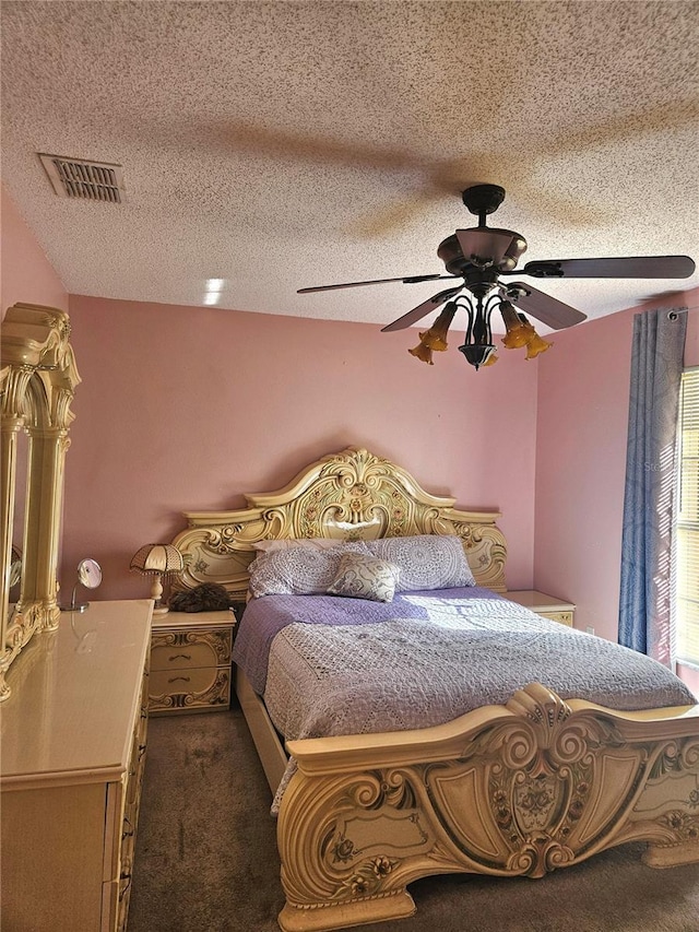 carpeted bedroom with a textured ceiling and ceiling fan