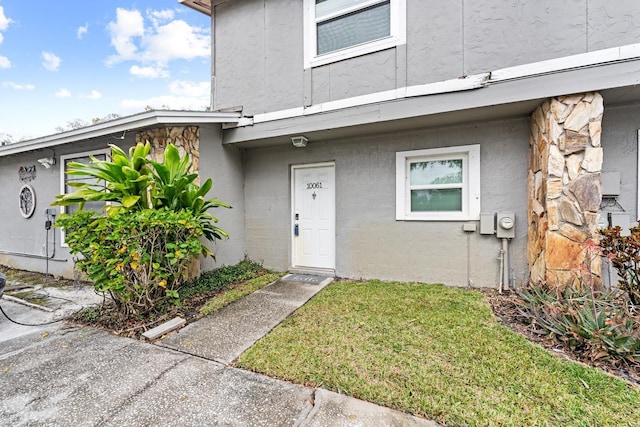 entrance to property with a yard