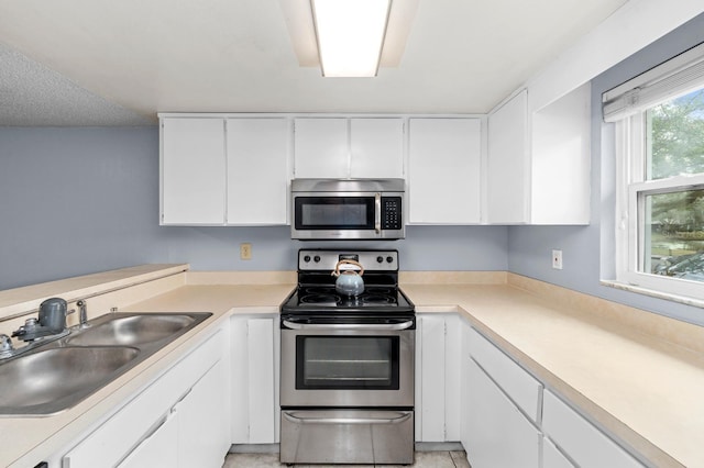 kitchen featuring sink, white cabinets, and appliances with stainless steel finishes