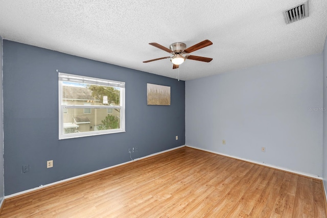 spare room featuring ceiling fan, wood-type flooring, and a textured ceiling