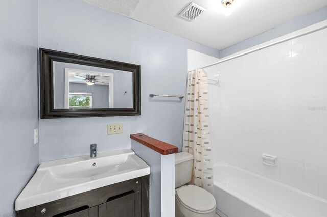 full bathroom with shower / bath combination with curtain, vanity, and toilet