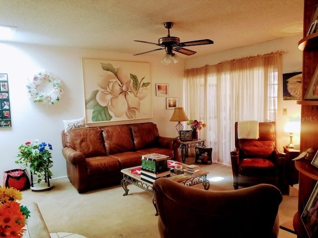 living room featuring ceiling fan, a textured ceiling, and carpet flooring