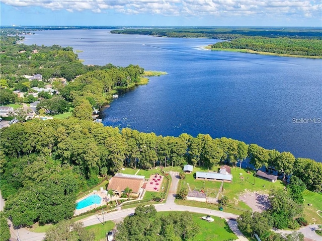 aerial view with a forest view and a water view