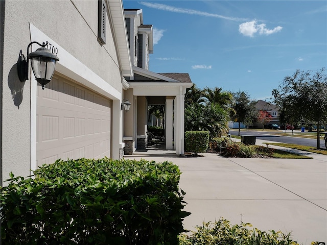 5709 Camila Song Ln, Tampa, FL 33625 - property entrance featuring an attached garage and stucco siding