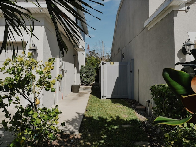 5709 Camila Song Ln, Tampa, FL 33625 - view of side of home featuring fence and stucco siding