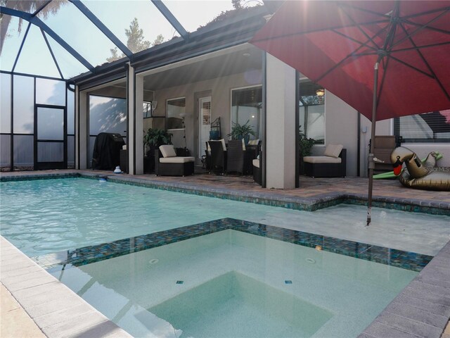 5709 Camila Song Ln, Tampa, FL 33625 - view of swimming pool featuring a pool with connected hot tub, glass enclosure, and a patio