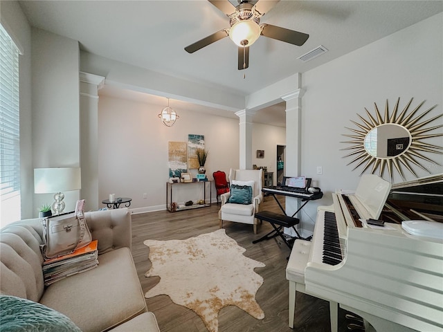 5709 Camila Song Ln, Tampa, FL 33625 - living area with decorative columns, visible vents, baseboards, a ceiling fan, and wood finished floors
