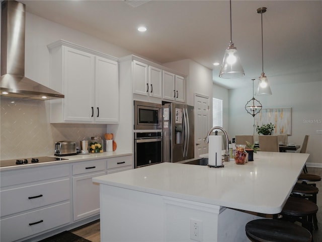5709 Camila Song Ln, Tampa, FL 33625 - kitchen with stainless steel appliances, backsplash, white cabinetry, a sink, and wall chimney range hood