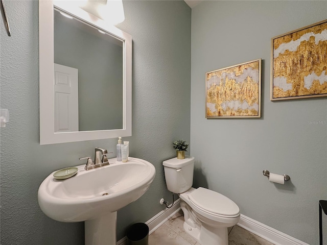 5709 Camila Song Ln, Tampa, FL 33625 - bathroom featuring baseboards, a sink, toilet, and tile patterned floors