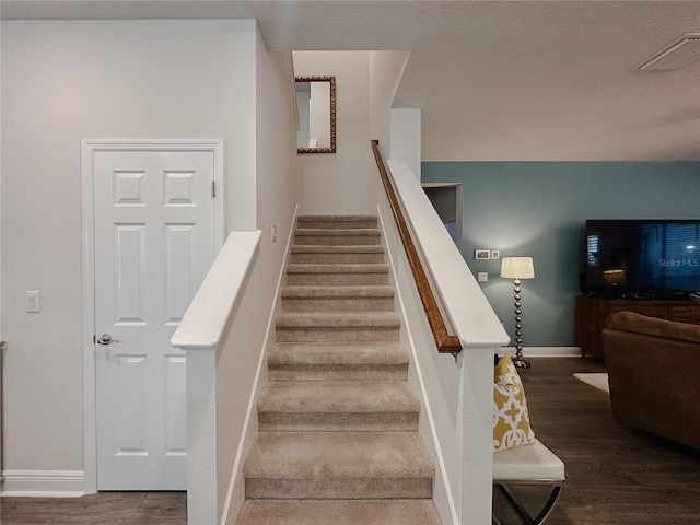 5709 Camila Song Ln, Tampa, FL 33625 - stairs featuring baseboards, visible vents, and wood finished floors