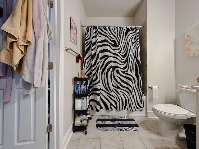 5709 Camila Song Ln, Tampa, FL 33625 - bathroom featuring a shower with shower curtain, a textured ceiling, toilet, and tile patterned floors