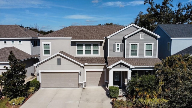 5709 Camila Song Ln, Tampa, FL 33625 - view of front facade with a garage, stucco siding, concrete driveway, and roof with shingles