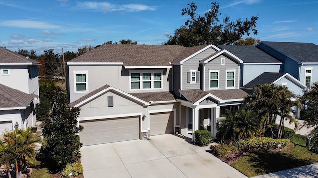 5709 Camila Song Ln, Tampa, FL 33625 - view of front of house featuring concrete driveway, a shingled roof, an attached garage, and stucco siding