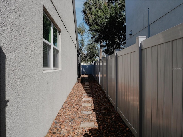 5709 Camila Song Ln, Tampa, FL 33625 - view of property exterior featuring a fenced backyard and stucco siding