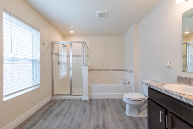 full bathroom with independent shower and bath, vanity, hardwood / wood-style floors, and toilet