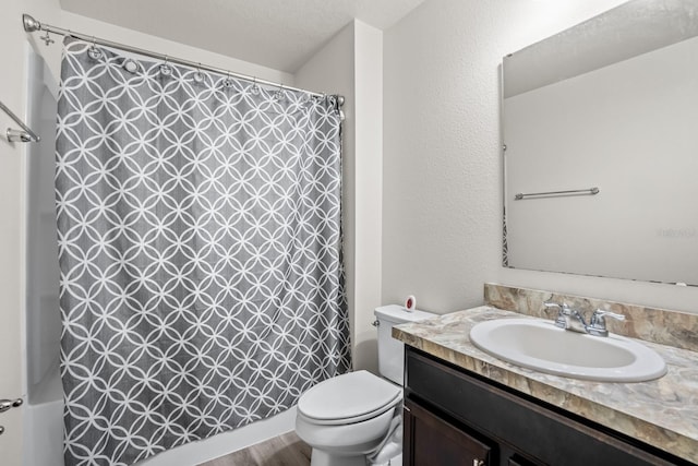 bathroom with vanity, hardwood / wood-style floors, a textured ceiling, and toilet