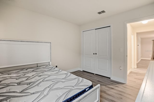 bedroom featuring a closet and light wood-type flooring