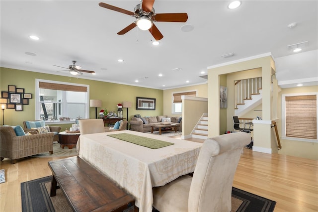 dining area featuring crown molding and light hardwood / wood-style floors