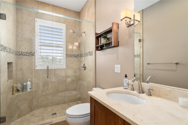 bathroom featuring walk in shower, vanity, and toilet