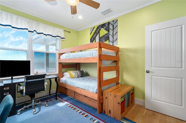 bedroom featuring hardwood / wood-style floors and crown molding