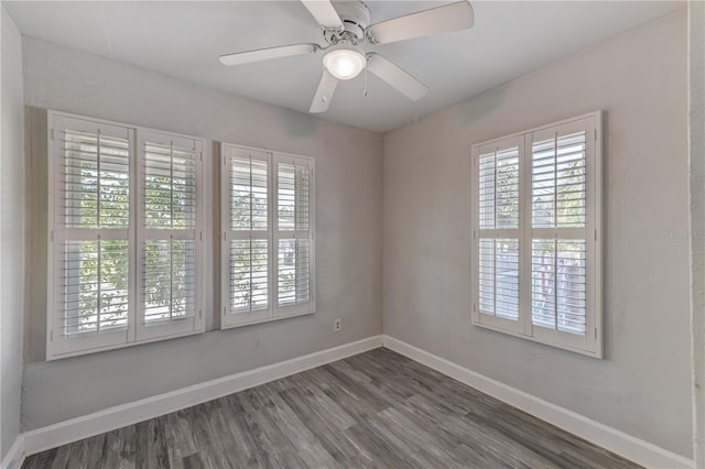 unfurnished room with dark hardwood / wood-style flooring, plenty of natural light, and ceiling fan