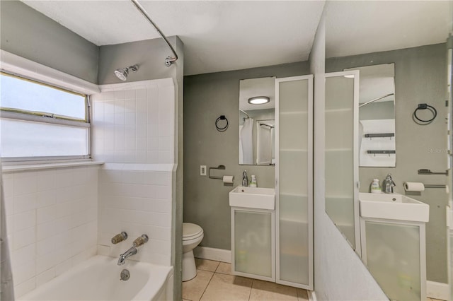 full bathroom with vanity, toilet, tiled shower / bath combo, and tile patterned flooring