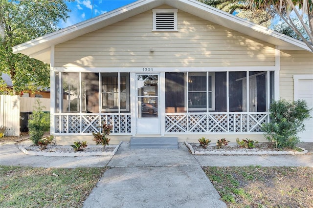 view of front of house featuring a sunroom