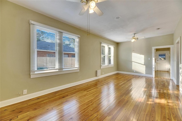 empty room with ceiling fan and hardwood / wood-style floors