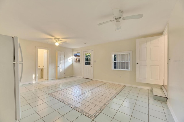 tiled foyer with ceiling fan