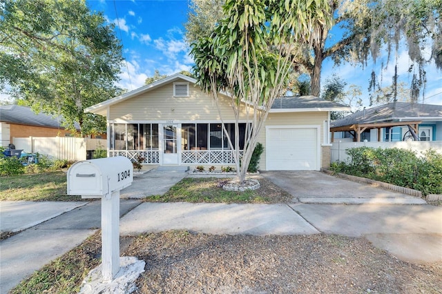 view of front of house with a garage and a sunroom