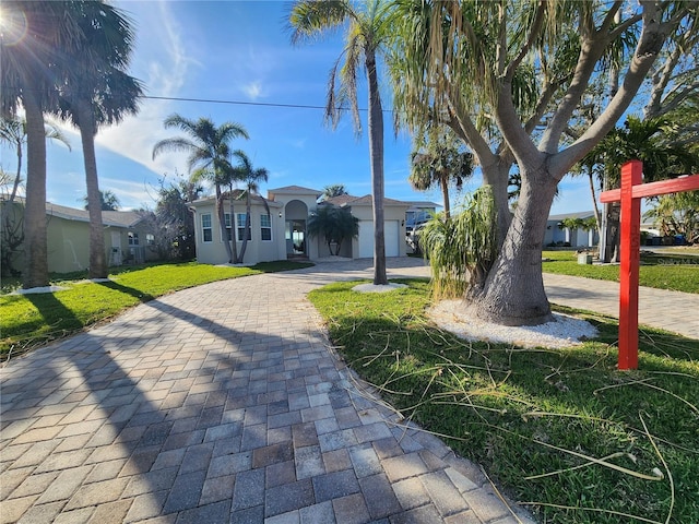 view of front of home with a garage and a front yard